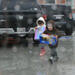 California sloshes through epic rain, snows