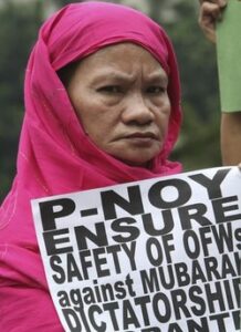 A Filipino Muslim woman displays a message as they picket the Foreign Affairs office in Manila Monday Jan. 31, 2011 to urge the Philippine Government to ensure the safety of Filipinos in Egypt, known as OFWs (Overseas Filipino Workers), following days of protests against the 30-year-rule of Egyptian President Hosni Mubarak. Officials said more than 6,000 Filipinos are working in Egypt and has drawn contingency plans for the possible repatriation of its citizens. (MNS Photo)