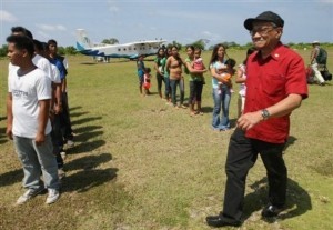 Philippine Congressman Walden Bello, right, walks past local residents and municipal employees of Pagasa Island, part of the disputed Spratly group of islands, in the South China Sea located off the coast of western Philippines Wednesday, July 20, 2011. China protested a trip made by Filipino lawmakers to disputed areas in the South China Sea to assert the claim of the Philippines. Ethan Sun, spokesman for the Chinese embassy in Manila, said the trip scheduled was 'against the spirit' of a code of conduct signed by claimants to the areas in 2002. The Spratlys, believed to be rich in oil, mineral and marine resources, are also claimed in whole or partly by Brunei, Malaysia, Vietnam and Taiwan. (AP Photo/Rolex Dela Pena, Pool)