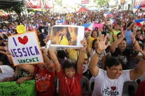 Relatives and supporters of American Idol finalist Jessica Sanchez celebrate during the live feed of the show's finale in Samal town, Bataan province