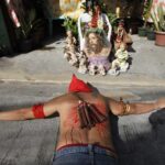 A hooded penitent with a bloodied back prays while lying on his belly in front of an image of Jesus Christ during Maundy Thursday Lenten rites in Mandaluyong city, metro Manila March 28, 2013. Maundy Thursday or Holy Thursday is the day Christians commemorate the Last Supper of Jesus Christ. Holy Week is celebrated in many Christian traditions during the week before Easter. (MNS photo)