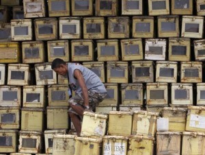 A worker walks on top of a pile ballot boxes after arranging and storing the boxes at a warehouse in Manila April 25, 2013. About 51 million people will cast their votes by using a Precinct Count Optical Scan (PCOS) system for a mid-term election on May 13, a Commission on Elections (COMELEC) said. (MNS photo)