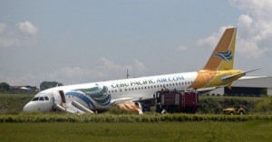 A Cebu Pacific Air Airbus A320-200 passenger jet is seen with its nose touching a grassy area at Davao International airport in southern Philippines June 3, 2013, after it overshot a runway on Sunday evening. Local media reported that the airport was shut down on Sunday night after the Cebu Pacific Air flight from Manila overshot and veered on the right side of a runway. All of the 165 passengers were unhurt. (MNS photo)