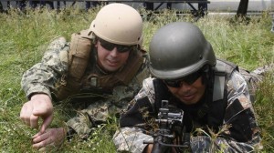 A U.S. Navy serviceman (left) takes up position with a Philippine Navy serviceman at a live fire exercise during a joint annual military exercise called “Carat” at former U.S. military base Sangley Point in Cavite city, west of Manila June 28, 2013. (MNS photo)