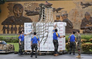 Marine stands on top of boxes containing tent material from U.S. relief organisation USAid, as he and Philippine soldiers prepare the load to be deployed by airlift by U.S. military to victims of super typhoon Haiyan, at Manila airport November 13, 2013. Philippine officials have been overwhelmed by Haiyan, one of the strongest typhoons on record, which tore through the central Philippines on Friday and flattened Tacloban, coastal capital of Leyte province where officials had feared 10,000 people died, many drowning in a tsunami-like wall of seawater. (MNS photo)