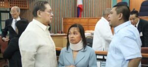 Former Philippine President Gloria Macapagal Arroyo, now a sitting lawmaker in the lower house of Congress, is flanked by husband Jose Miguel Arroyo (L) and her son Congressman Juan Miguel Arroyo inside the Sandiganbayan anti-graft court in Quezon City, Metro Manila, April 11, 2012. Arroyo entered a plead of not guilty before an anti-corruption court for her role in an aborted $329 million broadband deal with China's ZTE Corp in 2007 after a congressional inquiry in 2008 showed she allegedly did not stop her allies from collecting huge pay offs for the deal. Arroyo's husband, a former communications minister and the former head of the country's elections agency are facing similar corruption charges. REUTERS/Renz Joshua Posedio/ Philippine National Police-Public Information Office/Handout
