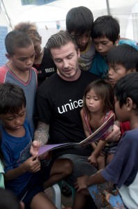 With a UNICEF shirt on, football superstar David Beckham reads to young Filipino children during his visit to the devastated city of Tacloban on Thursday. This iconic shot was posted on Michael Beckham Facebook page, which he personally “liked.”