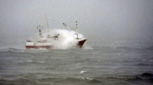 A fishing boat is hit by a wave near the coastal city of Burela, northwestern Spain, on Tuesday, Feb. 4, 2014. Spanish coastguards rescued five Filipino sailors by helicopter after the seamen’s boat got caught in a storm on Tuesday off northwestern Spain, where fresh sea gales were growing, authorities said. AFP PHOTO/MIGUEL RIOPA