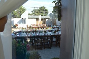 Glimpse of the setting in the courtyard where the reception was held. Vibrant red hues paired with vintage vases evoked the essence of vintage/rustic wedding, designed by Crystal Sanford of Recycled Love Story